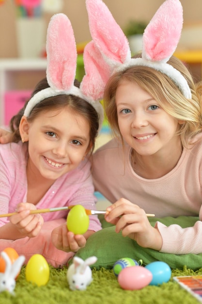 Two cute girls painted Easter eggs