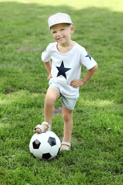 Two cute little boys playing football