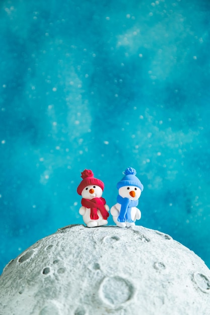 Two cute plasticine snowmen on the moon