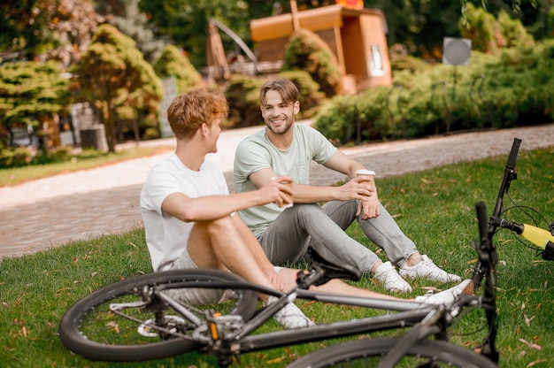 Two cyclists having a coffee break outside