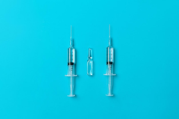 Two dialed syringes with a medicine and with an ampoule with a medicine. Health concept. Medicine concept. 