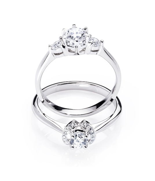 two diamond engagement wedding rings on isolated white background