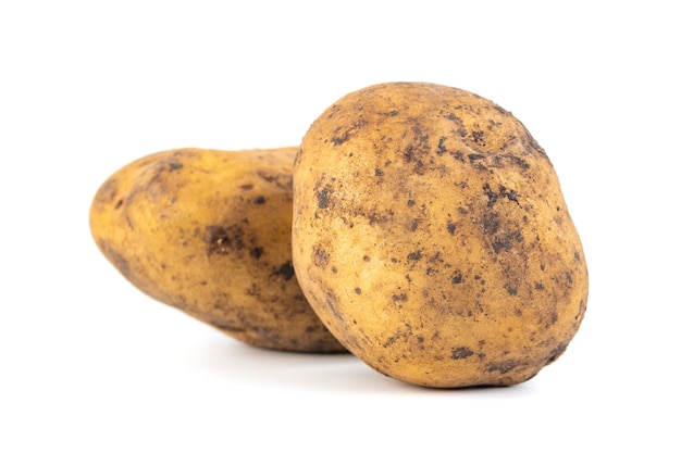 Two dirty potatoes isolated on white surface