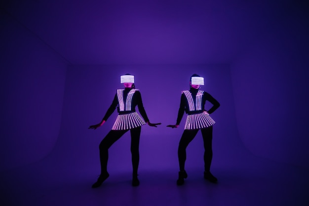 Two disco dancers move in UV costumes.