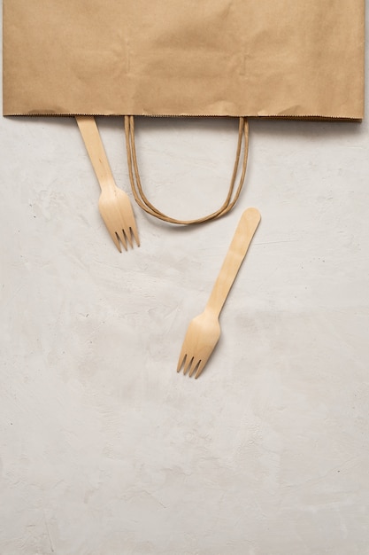 Two disposable wooden forks and craft bag