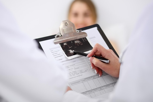 Two doctors discussing a patient ultrasound. Health care and medicine concept