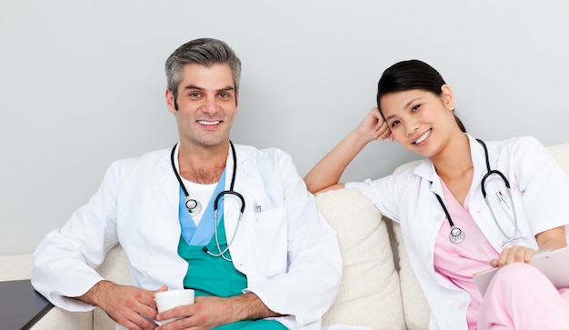 Two doctors relaxing and drinking coffee