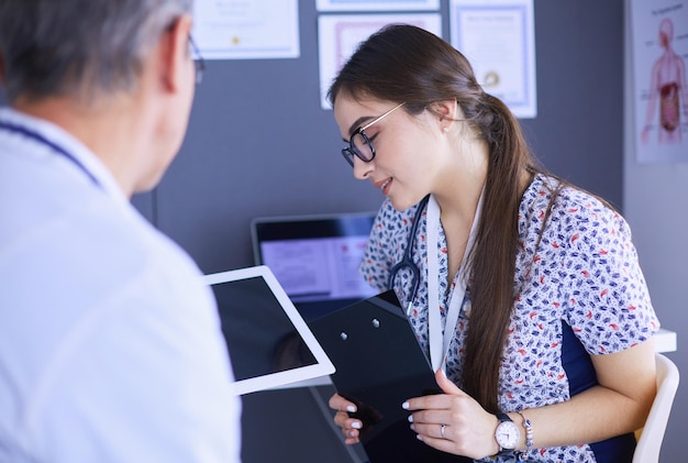 Two doctors speaking in a bright office