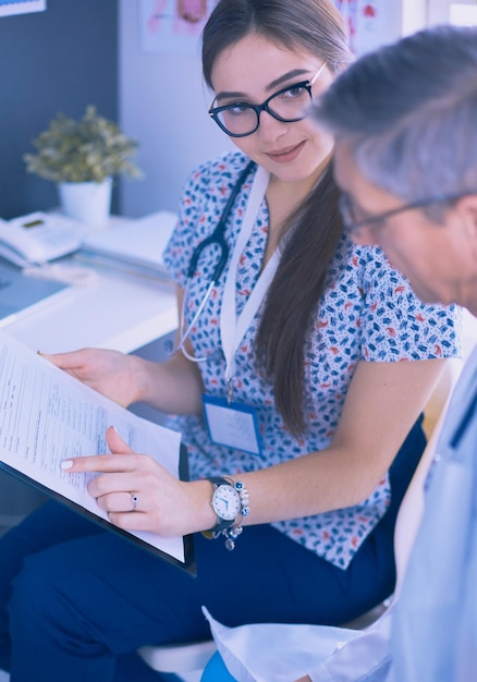 Two doctors speaking in a bright office