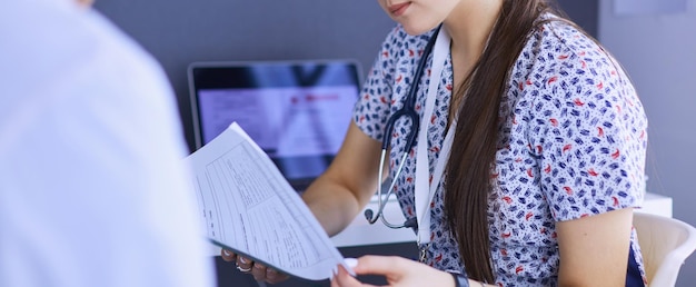 Two doctors speaking in a bright office