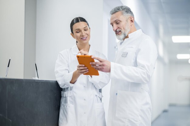 Two doctors talking in the hospital during the shift change