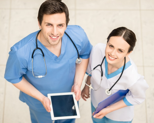 Two doctors working together with digital tablet.