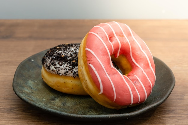 two donuts stacked over each other, made of red fruits and other of chocolate
