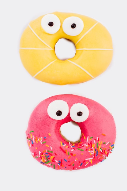 Two donuts with funny eyes.