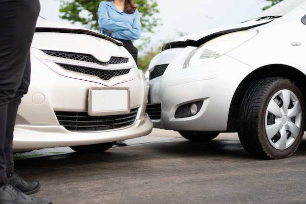 two drivers check for damage after a car accident before taking pictures and sending insurance