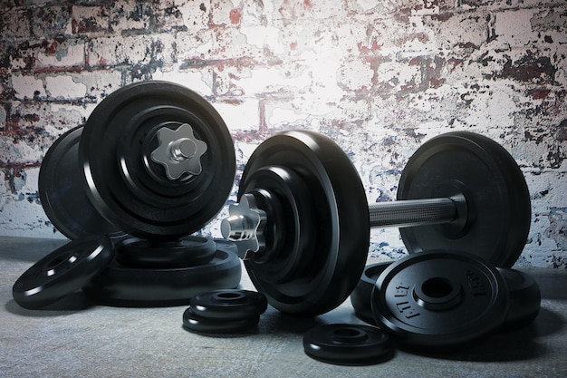 Two dumbbells with brick wall in the background 3D Render