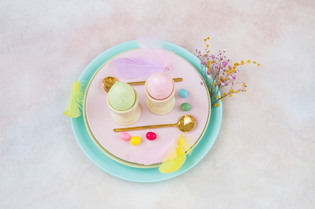 Two eggs, two spoons and decor for Easter