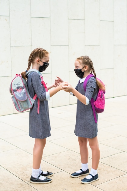 Two elementary school students, with medical masks