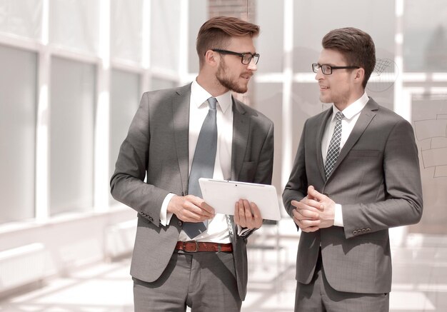 Two employees standing in the office