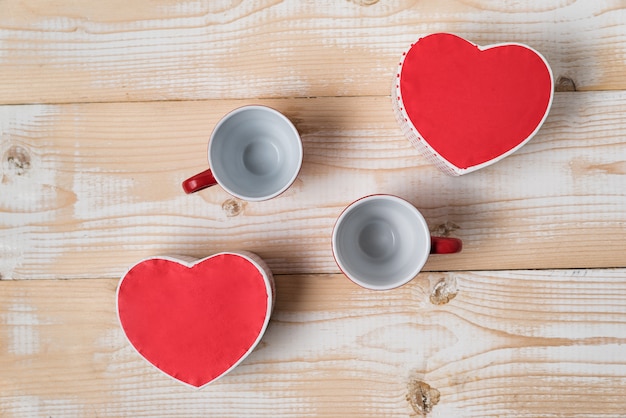 Two empty cups and heart shaped boxes. Date, Valentine's Day. Top view