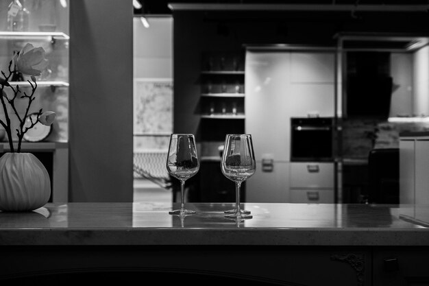 Two empty glasses in the kitchen black and white photo high quality photo