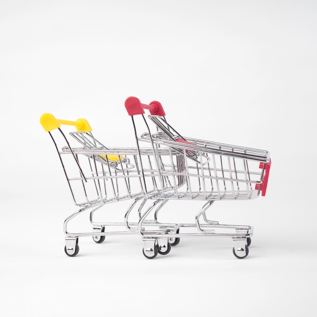 Photo two empty grocery shopping cart. isolated over white background.