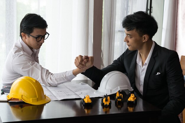 Two engineer or businessman engage in arm wrestling