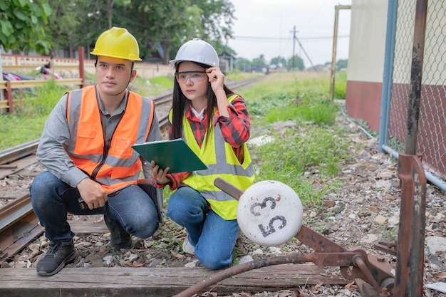 Two engineer working at train stationWork together happilyHelp each other analyze the problemConsult about development guidelines