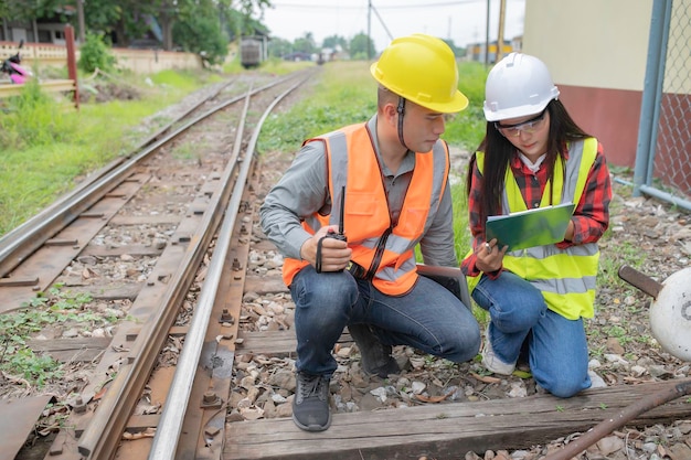 Two engineer working at train stationWork together happilyHelp each other analyze the problemConsult about development guidelines