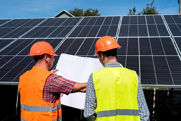Two engineers discussion plan to find problem solar photovoltaic panels