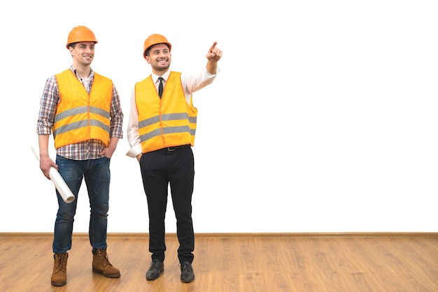 The two engineers gesture on the white wall background