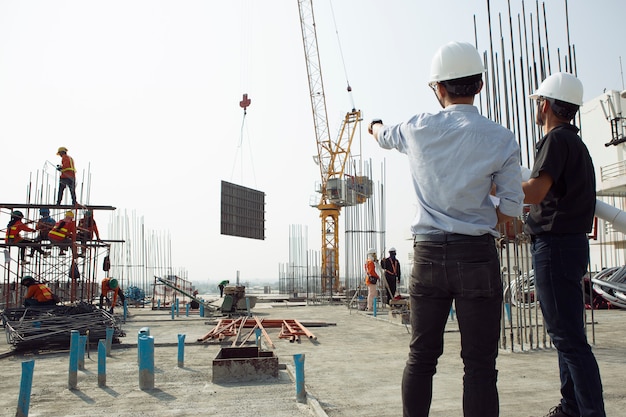 Two engineers work on the construction site