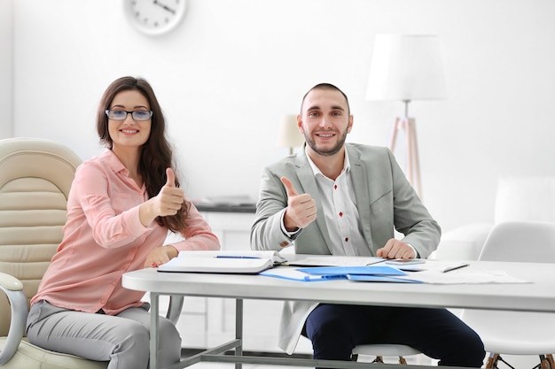 Two estate agents,  in bright office