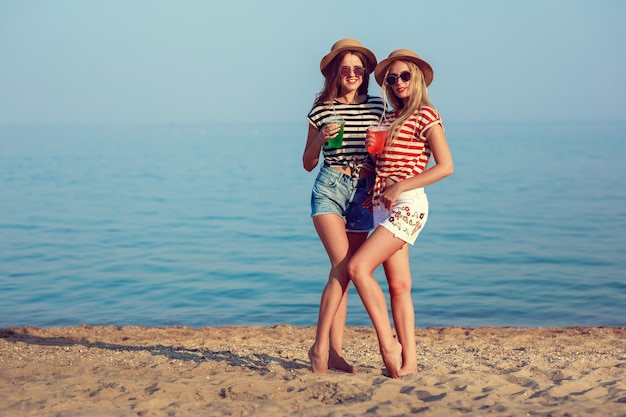 Two European girls have fun in the summer on the beach