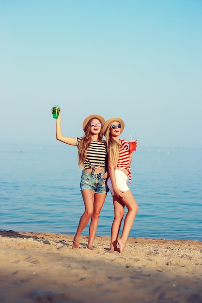 Two European girls have fun in the summer on the beach