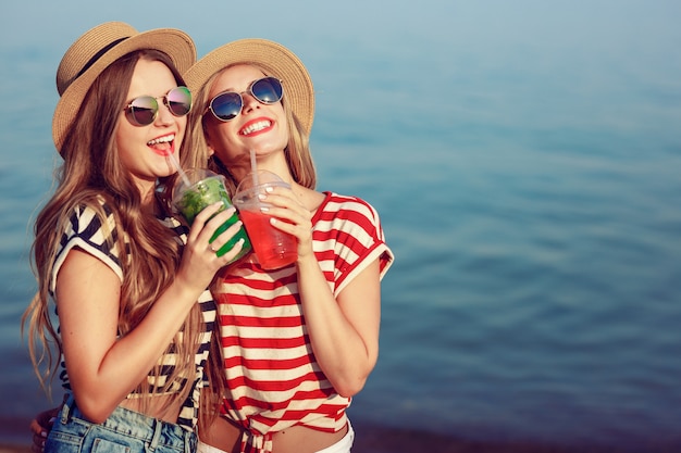 Two European girls have fun in the summer on the beach