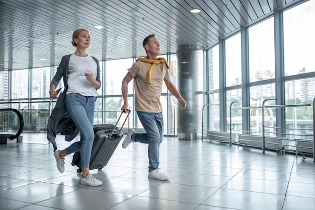 Two excited tourists hurrying to catch the flight