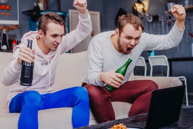 Two fans watching football rejoice over the team