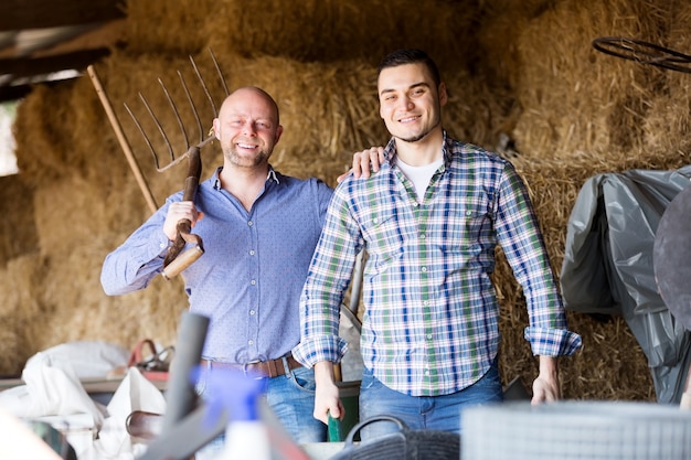 Two farm workers in hayloft