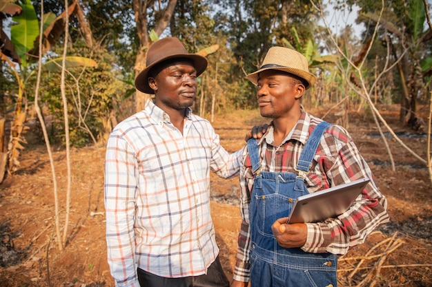 Two farmers negotiating in a field agriculture in Africa