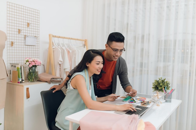 Two fashion designers working together on a desk