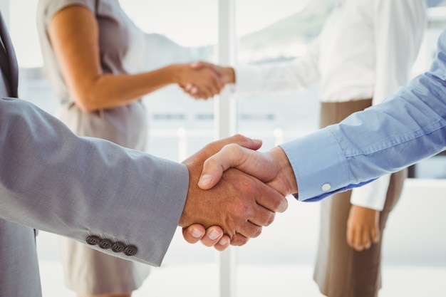 Two fellow employees shaking hands