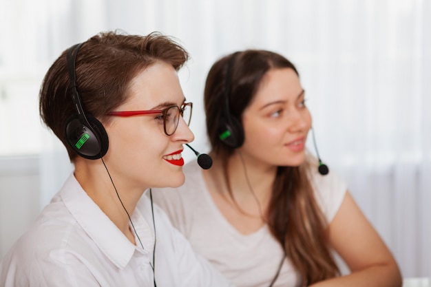 Two female call center operators working on a computer