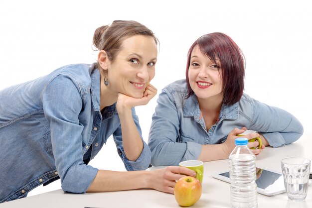 Two female colleagues are making a  coffee break