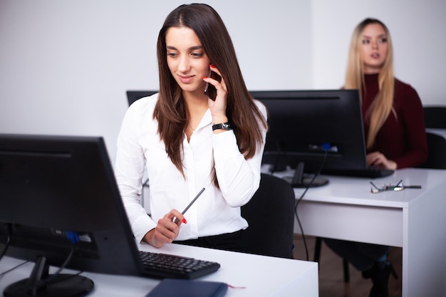 Two female colleagues in office working together Two female colleagues in office working together