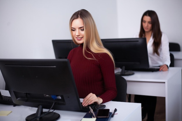 Two female colleagues in office working together