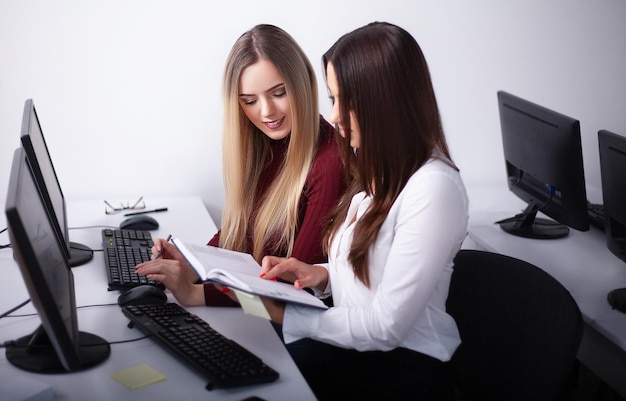 Two female colleagues in office working together