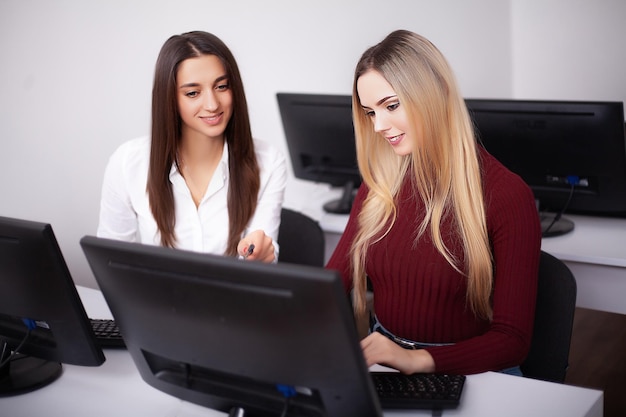 Two female colleagues in office working together