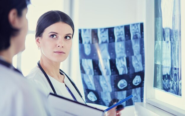 Two female doctors looking at xrays in a hospital