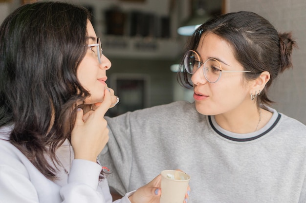 Two female friends eating ice cream.